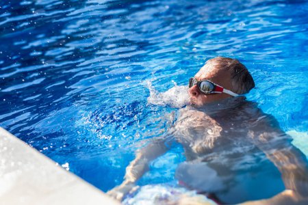 Photo for Middle aged man diving in the pool. - Royalty Free Image