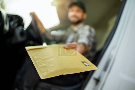 Photo for Young handsome delivery guy getting his deliveries ready. - Royalty Free Image