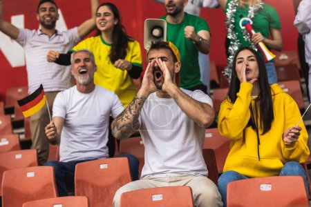 Téléchargez les photos : Les fans allemands de football / football applaudissent au stade avec des drapeaux et d'autres équipements - en image libre de droit