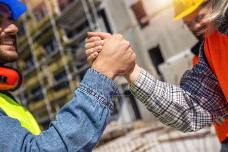Photo for Contractor. construction worker team hands shaking after plan project contract  at construction site, contractor, engineering, partnership, construction concept - Royalty Free Image