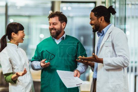 Photo for Group of multiracial doctors standing and discussing about results. - Royalty Free Image