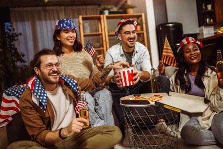 Photo for Multiracial group of friends watching sport at home with American flags. - Royalty Free Image