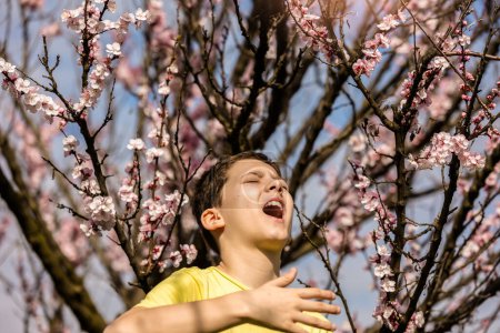 Photo for Child with pollen allergy. Boy sneezing because of seasonal allergy. - Royalty Free Image
