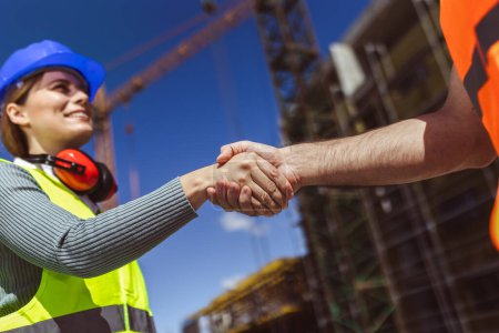 Photo for Contractor. construction worker team hands shaking after plan project contract  at construction site, contractor, engineering, partnership, construction concept - Royalty Free Image
