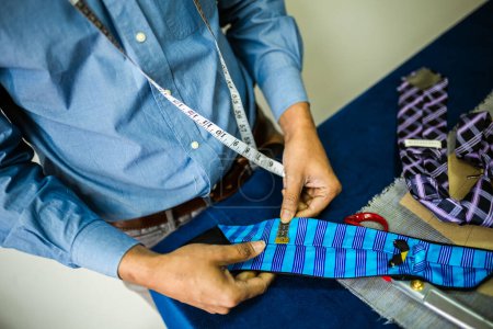 Photo for African American men fashion designer, tailor making a tie. - Royalty Free Image