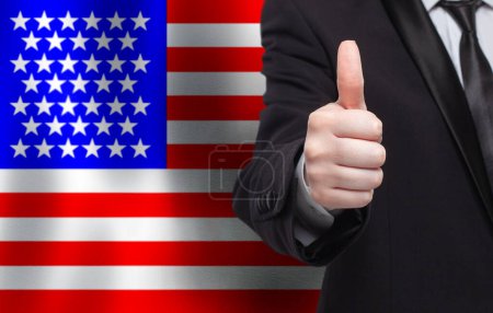 Photo for American concept. Businessman showing thumb up on the background of flag of USA - Royalty Free Image