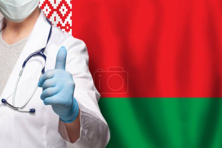 Belarussian doctor's hand showing thumb up positive gesture on flag of Belarus background