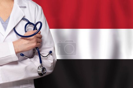 Yemeni medicine and healthcare concept. Doctor close up against flag of Yemen background
