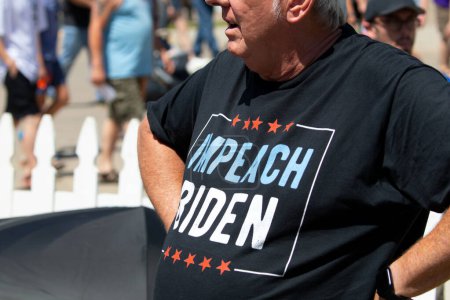 Photo for Des Moines, Iowa, USA - August 12, 2023: A man wearing an Impeach Biden t-shirt at the Iowa state fair in Des Moines, Iowa, United States. - Royalty Free Image