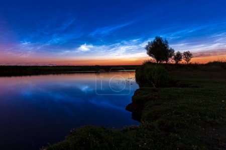Noctilucent clouds also polar mesospheric clouds or night shining clouds reflection in water