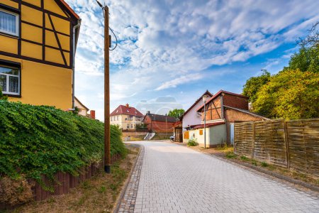 Wollersleben, Thuringen, Germany, old village street view. Narrow alley, old architexcture and church