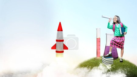 Photo for Asian little girl holding a book and looking at something with a flying rocket in the sky background. National Science Day - Royalty Free Image