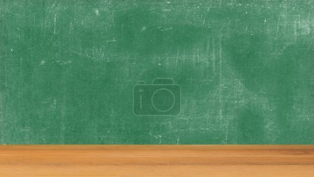 Photo for Wooden table with a chalkboard background - Royalty Free Image