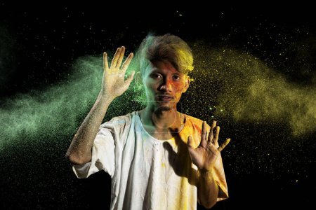 Photo for Portrait of a man celebrating Holi with colorful Holi powder. Holi festival concept - Royalty Free Image