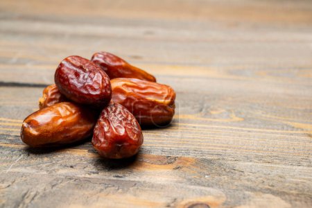 Photo for Dried dates fruit for iftar on Ramadan on a wooden table - Royalty Free Image