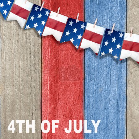 Photo for Closeup view of the American flag hanging on the rope on a wooden background. 4th of July concept - Royalty Free Image