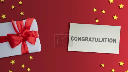 Photo for Gift box and paper with Congratulations text on colored background. Congratulation concept - Royalty Free Image