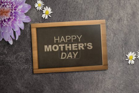 Photo for Small chalkboard with Happy Mother's Day text on a black background. Mothers day concept - Royalty Free Image