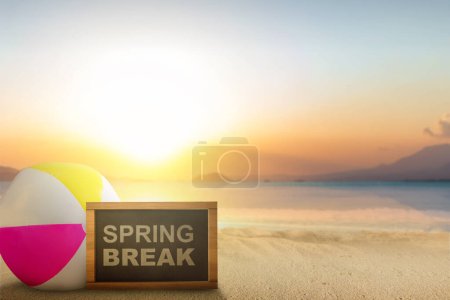 Photo for Beach ball and small chalkboard with Spring Break text on the beach. Spring break concept - Royalty Free Image