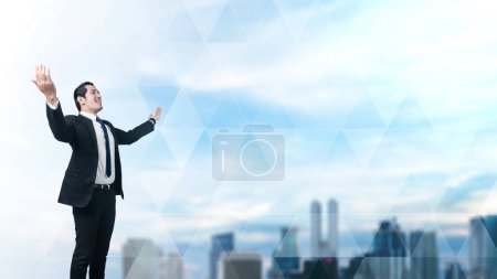 Foto de Portrait of a confident businessman posing with arms raised with a cityscape background - Imagen libre de derechos