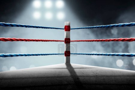 Foto de Red and blue rope on the boxing ring corner in the stadium arena - Imagen libre de derechos