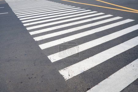 Foto de Image of an empty pedestrian crosswalk with no people. Zebra cross. Safety, right way, compliance with traffic rules concept idea. - Imagen libre de derechos