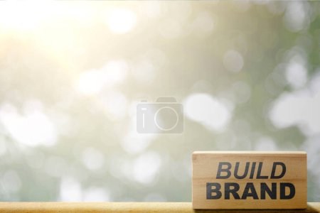 Foto de Wooden block with build brand text on the table. Build brand concept - Imagen libre de derechos