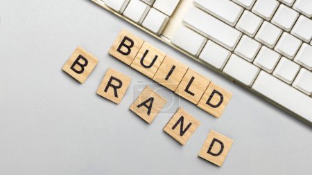 Foto de Small wooden cube with a build brand letter on a white background. Build brand concept - Imagen libre de derechos