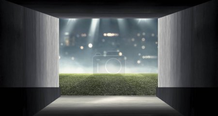 Gang zum Fußballplatz in einem Sportstadion mit beleuchtetem Scheinwerferhintergrund