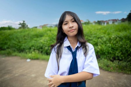 Foto de Portrait of Asian Junior High School student girl in uniform carrying backpack going to school in the morning - Imagen libre de derechos