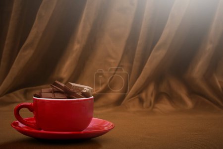 Foto de Chocolate pieces on chocolate drink in the cup on the table. World Chocolate Day concept - Imagen libre de derechos