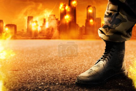 Image of demolished city in  from military aggression at night with fire and appearance of an army boots appearance. Smoke and fire from skyscarper at downtown from terorism attack. 