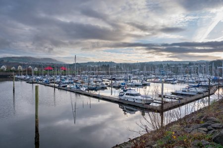 Photo for Looking over to the entrance of Kip Marina which fronts the village of Inverkip with the marina village and harbour view in the far distance. Many yachts are presently berthed in the marina for the winter months - Royalty Free Image
