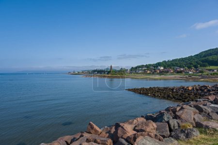Photo for The town of Largs set on the Firth of Clyde on the West Coast of Scotland. Looking from the marina into the town past the Pencil monument on a summers day - Royalty Free Image