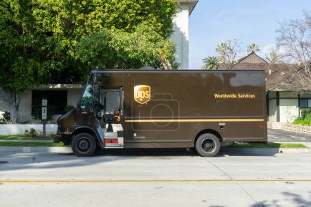 Photo for A UPS truck parked in front of an apartment building. - Royalty Free Image