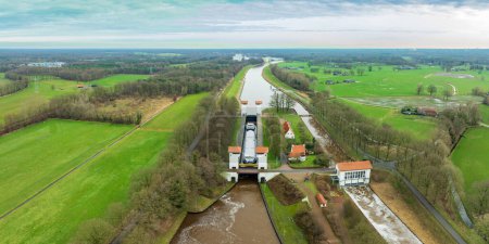 aerial photo of a ship in the Wiene sluice in the Twente Canal, netherlands. It bridges a height difference of 6 meters