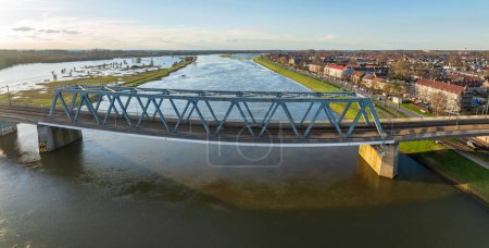 aerial shot of the Deventer railroad bridge over the ijssel river in the Netherlands