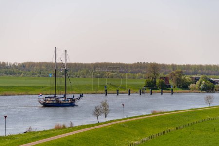 classic sailboat on the IJssel river near Kampen, Netherlands