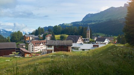 Photo for Churwalden village in Switzerland. Formerly Parpan. Beautiful swiss alpine countryside with a medieval bell tower. Place near Lenzerheide Pass at Grisons Alps in Graubunden canton. - Royalty Free Image