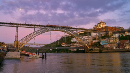 Photo for View at old town Porto, Portugal with bridge Ponte Dom Luis over Douro river. Oporto, touristic city of culture, architecture, wine, sport and gastronomy. - Royalty Free Image