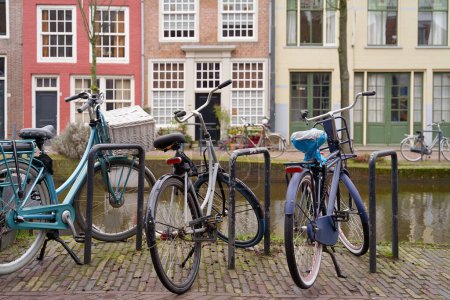 Photo for Bicycles parked alongside a channel on beautiful old buildings background. - Royalty Free Image