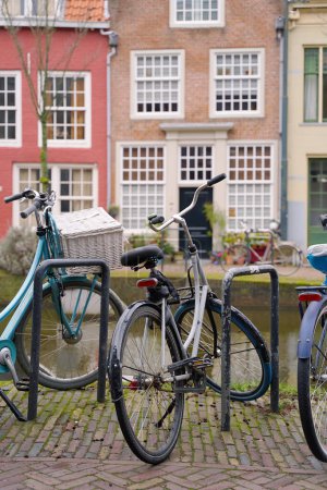 Photo for Bicycles parked alongside a channel on beautiful old buildings background. - Royalty Free Image