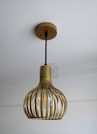 Photo for Suspended striped hollow shade chandelier in loft style in a modern house interior - Royalty Free Image