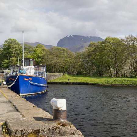 Photo for Pleasure boat souters lass moored on the caledonian canal at corpach near fort william with ben nevis in background - Royalty Free Image