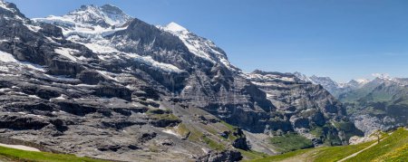 Photo for Panoramic view of the jungfrau and silberhorn from eigergletscher with the schilthorn above murren in the distance on the right - Royalty Free Image