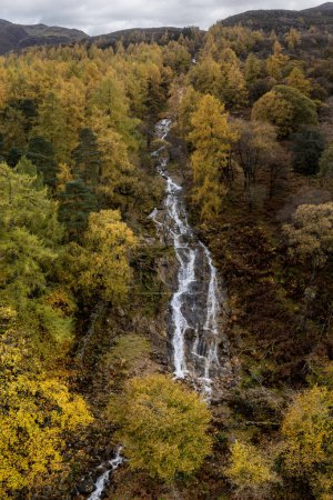 Photo for Sour milk gill waterfall on red pike at buttermere lake district with autumn colours elevated view - Royalty Free Image