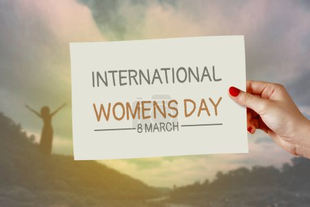Photo for International women's day card on hand. Greeting for 8 March Happy Womens Day & 25 November International Day for the Elimination of Violence against Women. - Royalty Free Image