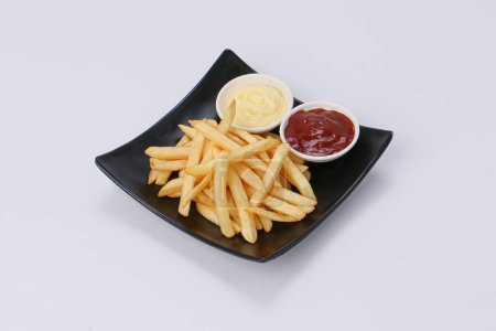 Téléchargez les photos : Fresh fried french fries with ketchup and mayonnaise in a dish isolate background. - en image libre de droit