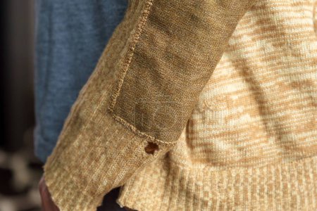 Photo for Patch on a man wool sweater. Mending clothes we sew, wear, repair. Selective focus - Royalty Free Image