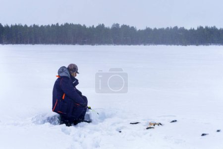 Photo for Man Holding in Hands rod. Winter fishing. Copy space. Winter activity. Copy space - Royalty Free Image